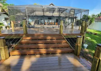 Wide composite deck steps leading to a pool screen enclosure