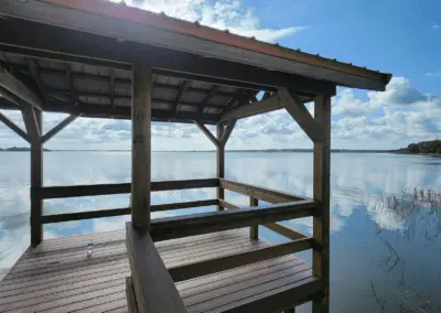 Covered dock with built-in bench overlooking a wide lake