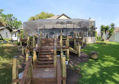 Composite deck stairs leading up to a pool screen enclosure